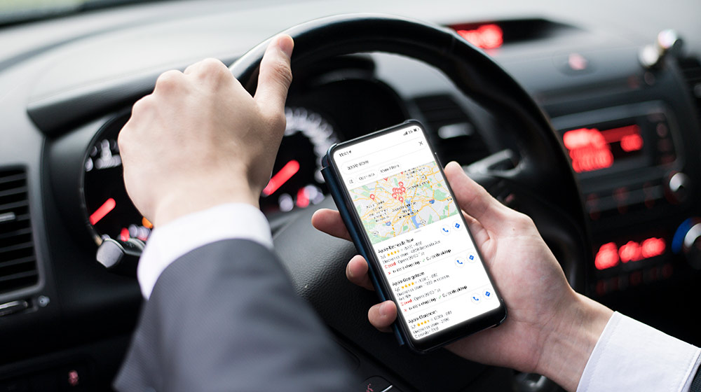 businessman doing google search on phone while driving | Feature | 5 Ways to Rank Higher on Google Maps in 2021
