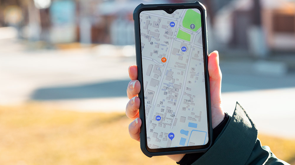 Handing holding smartphone showing online map and locations | Feature | Google Maps is the New SEO!